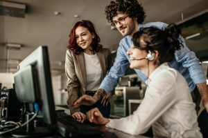 Managed IT support team helping a business user troubleshoot a computer